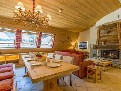 a living room with a table and a fireplace at Apartment in Chamonix Centre-Ville by Interhome in Chamonix-Mont-Blanc