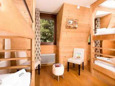 a room with two bunk beds and a chair at Apartment in Chamonix Centre-Ville by Interhome in Chamonix-Mont-Blanc