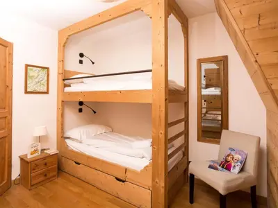 a bunk bed in a room with a chair and a mirror at Apartment in Chamonix Centre-Ville by Interhome in Chamonix-Mont-Blanc