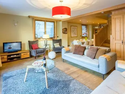 a living room with a couch and a table at Apartment Chamois Apartment by Interhome in Chamonix-Mont-Blanc
