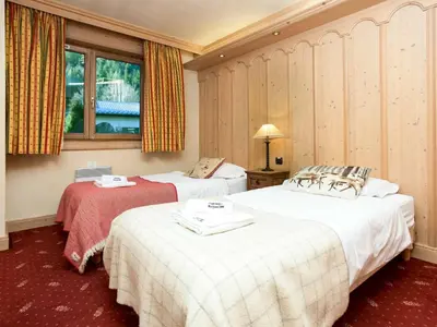 a hotel room with two beds and a window at Apartment Chamois Apartment by Interhome in Chamonix-Mont-Blanc