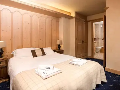 a bedroom with a bed with towels on it at Apartment Chamois Apartment by Interhome in Chamonix-Mont-Blanc