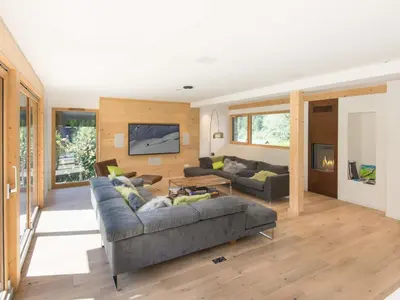 a living room with a couch and a tv at Holiday Home Chalet Montana by Interhome in Chamonix-Mont-Blanc