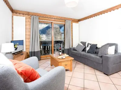 a living room with two couches and a table at Apartment in Chamonix mit geräumigem Balkon und weitem Blick by Interhome in Chamonix-Mont-Blanc