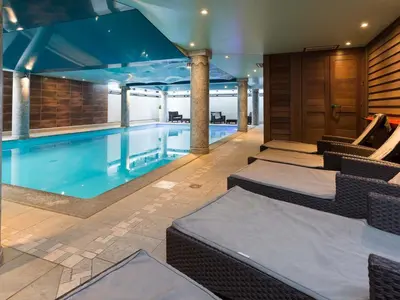 a large swimming pool with chairs at Apartment in Chamonix mit geräumigem Balkon und weitem Blick by Interhome in Chamonix-Mont-Blanc