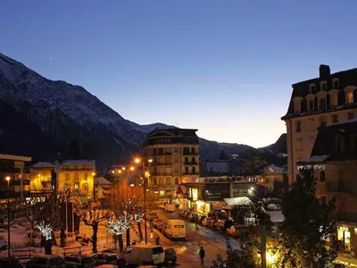 a city at night with mountains in the background at Apartment in Chamonix mit geräumigem Balkon und weitem Blick by Interhome in Chamonix-Mont-Blanc
