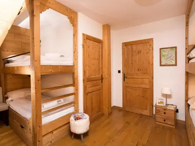 a bedroom with a bunk bed and a door at Apartment Wohnung in Chamonix Centre-Ville by Interhome in Chamonix-Mont-Blanc