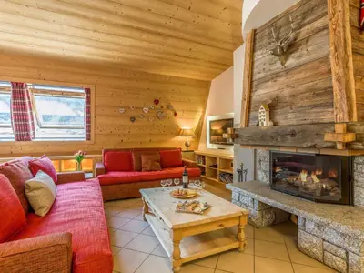 a living room with a fireplace in a log cabin at Apartment Wohnung in Chamonix Centre-Ville by Interhome in Chamonix-Mont-Blanc