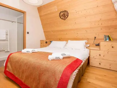 a bedroom with a bed with two towels on it at Apartment Wohnung in Chamonix Centre-Ville by Interhome in Chamonix-Mont-Blanc