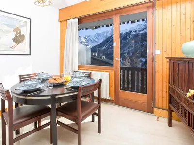 a dining room with a table and chairs and a window at Apartment Le Brevent Wohnung by Interhome in Chamonix-Mont-Blanc