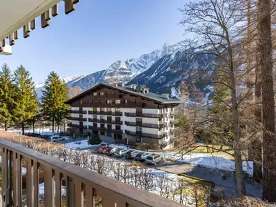 a balcony view of a hotel with mountains in the background at Apartment Le Brevent Wohnung by Interhome in Chamonix-Mont-Blanc