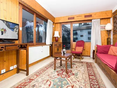 a living room with a couch and a tv at Apartment Le Brevent Wohnung by Interhome in Chamonix-Mont-Blanc