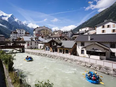 a group of people rafting down a river in a town at Apartment Wohnung in Chamonix Centre-Ville und Bergblick by Interhome in Chamonix-Mont-Blanc