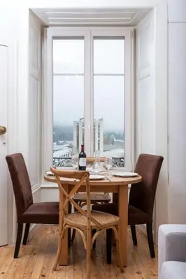 a dining room table with chairs and a window at Apartment Wohnung in Chamonix Centre-Ville und Bergblick by Interhome in Chamonix-Mont-Blanc