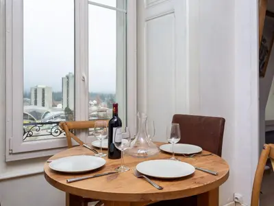 a wooden table with a bottle of wine and glasses at Apartment Wohnung in Chamonix Centre-Ville und Bergblick by Interhome in Chamonix-Mont-Blanc