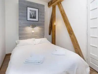 a bedroom with a white bed with two towels on it at Apartment Wohnung in Chamonix Centre-Ville und Bergblick by Interhome in Chamonix-Mont-Blanc