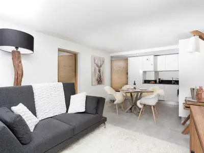 a living room with a couch and a dining room at Apartment La Cordee 412 mit Balkon by Interhome in Chamonix-Mont-Blanc