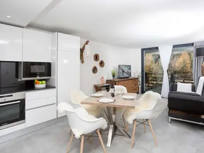 a kitchen and living room with a table and chairs at Apartment La Cordee 412 mit Balkon by Interhome in Chamonix-Mont-Blanc
