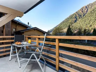 a table and chairs on the balcony of a cabin at Apartment La Cordee 412 mit Balkon by Interhome in Chamonix-Mont-Blanc