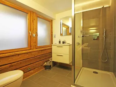 a bathroom with a toilet and a glass shower at Holiday Home für 10 Personen in Chaonix-Mont-Blanc- Französische Alpen - Savoyer Alpen by Interhome in Chamonix-Mont-Blanc