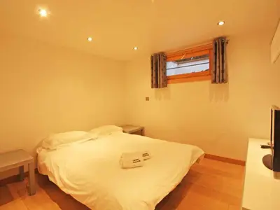a bedroom with a white bed and a window at Holiday Home für 10 Personen in Chaonix-Mont-Blanc- Französische Alpen - Savoyer Alpen by Interhome in Chamonix-Mont-Blanc