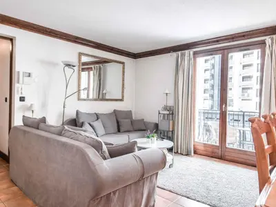a living room with a couch and a large window at Apartment Balmat Wohnung by Interhome in Chamonix-Mont-Blanc