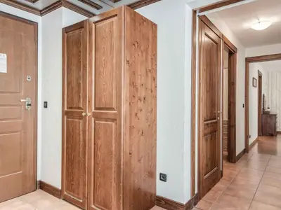 a hallway with wooden doors in a house at Apartment Balmat Wohnung by Interhome in Chamonix-Mont-Blanc