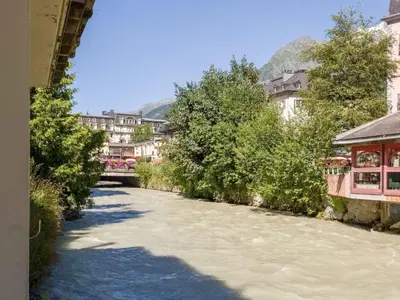 a river in a town with buildings and trees at Apartment Lou Lou Apartment by Interhome in Chamonix-Mont-Blanc