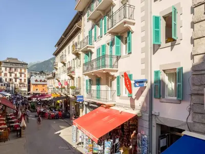a street in a town with people walking around at Apartment Lou Lou Apartment by Interhome in Chamonix-Mont-Blanc