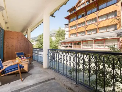 a balcony with a table and chairs and a building at Apartment Lou Lou Apartment by Interhome in Chamonix-Mont-Blanc