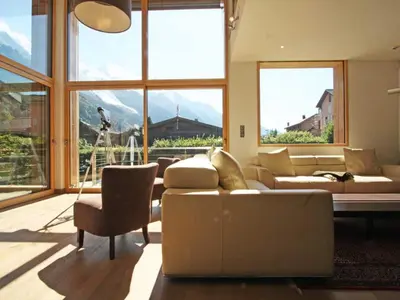 a living room with a couch and a view of mountains at Holiday Home Hütte Raphael by Interhome in Chamonix-Mont-Blanc