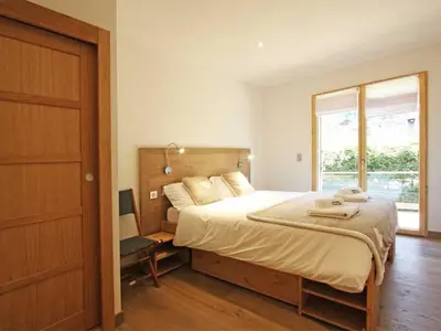 a bedroom with a large bed and a window at Holiday Home Hütte Raphael by Interhome in Chamonix-Mont-Blanc