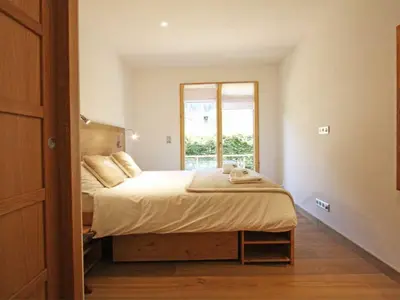 a bedroom with a large bed with a window at Holiday Home Hütte Raphael by Interhome in Chamonix-Mont-Blanc