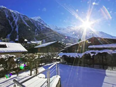 a view of a snow covered mountain with the sun at Holiday Home Hütte Raphael by Interhome in Chamonix-Mont-Blanc