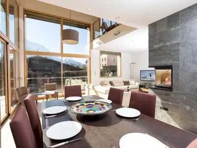 a living room with a table and chairs and a fireplace at Holiday Home Hütte Raphael by Interhome in Chamonix-Mont-Blanc
