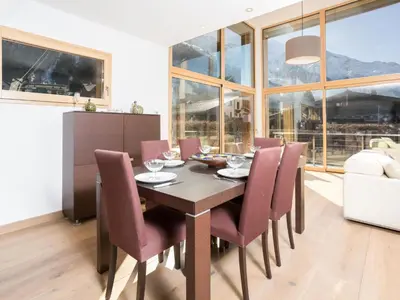 a dining room with a wooden table and chairs at Holiday Home Hütte Raphael by Interhome in Chamonix-Mont-Blanc