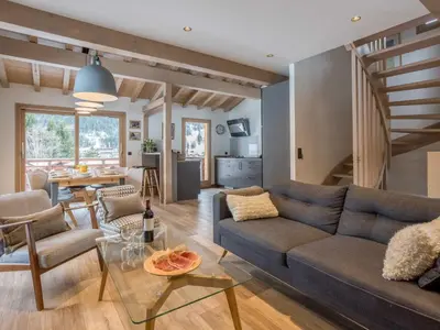 a living room with a couch and a table at Holiday Home Chalet de l'Ours - Bärenhütte by Interhome in Chamonix-Mont-Blanc