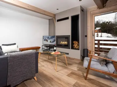 a living room with a couch and a fireplace at Holiday Home Chalet de l'Ours - Bärenhütte by Interhome in Chamonix-Mont-Blanc
