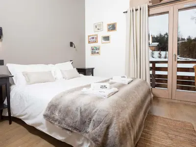a bedroom with a bed and a large window at Holiday Home Chalet de l'Ours - Bärenhütte by Interhome in Chamonix-Mont-Blanc