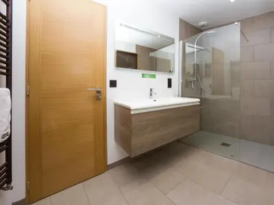 a bathroom with a sink and a shower at Holiday Home Chalet de l'Ours - Bärenhütte by Interhome in Chamonix-Mont-Blanc