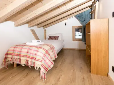 a bedroom with a bed and a wooden floor at Holiday Home Chalet de l'Ours - Bärenhütte by Interhome in Chamonix-Mont-Blanc