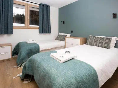 a bedroom with two beds and a window at Holiday Home Chalet de l'Ours - Bärenhütte by Interhome in Chamonix-Mont-Blanc