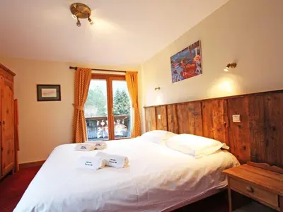 a bedroom with a bed with two towels on it at Apartment La Ferme des Praz Appt by Interhome in Chamonix-Mont-Blanc