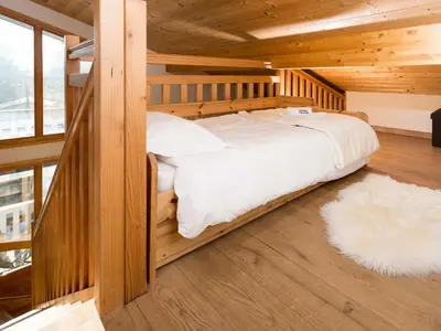 a bedroom with a bed in a wooden cabin at Apartment Wohnung Sauberands 18 mit Balkon by Interhome in Chamonix-Mont-Blanc