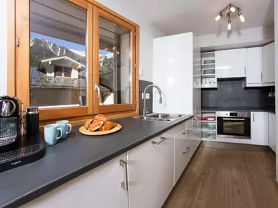 a kitchen with a plate of food on a counter at Apartment Wohnung Sauberands 18 mit Balkon by Interhome in Chamonix-Mont-Blanc