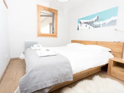 a bedroom with two beds and a mirror at Apartment Wohnung Sauberands 18 mit Balkon by Interhome in Chamonix-Mont-Blanc