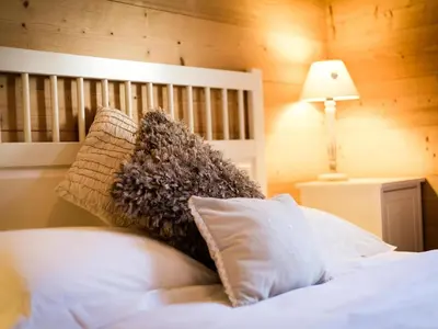 a bedroom with a bed with white sheets and pillows at Apartment Le Paradis 8 Wohnung by Interhome in Chamonix-Mont-Blanc