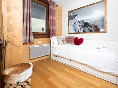 a bedroom with a bed with a heart on it at Apartment Le Paradis 8 Wohnung by Interhome in Chamonix-Mont-Blanc