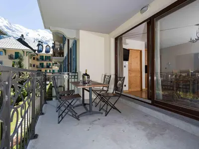 a patio with a table and chairs on a balcony at Apartment Le Paradis 8 Wohnung by Interhome in Chamonix-Mont-Blanc