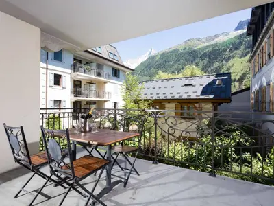 a table and chairs on a balcony with a view at Apartment Le Paradis 8 Wohnung by Interhome in Chamonix-Mont-Blanc